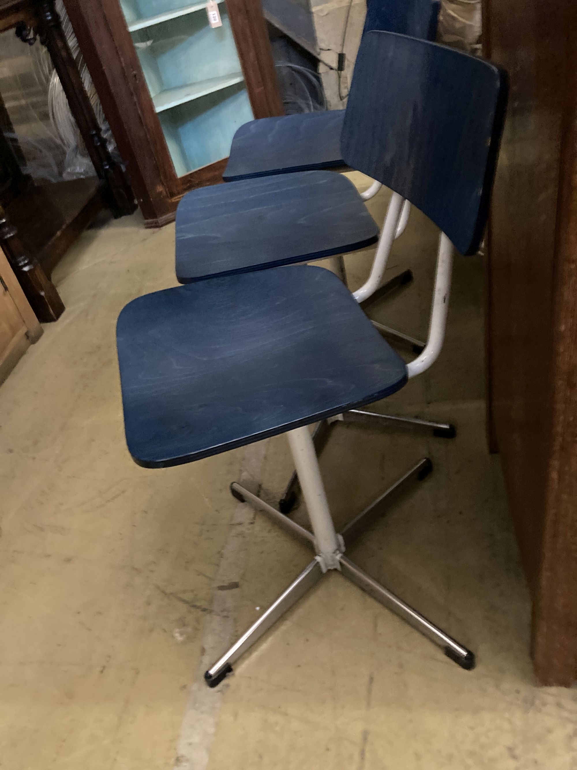 A set of three mid century stained beech and metal childs swivel chairs